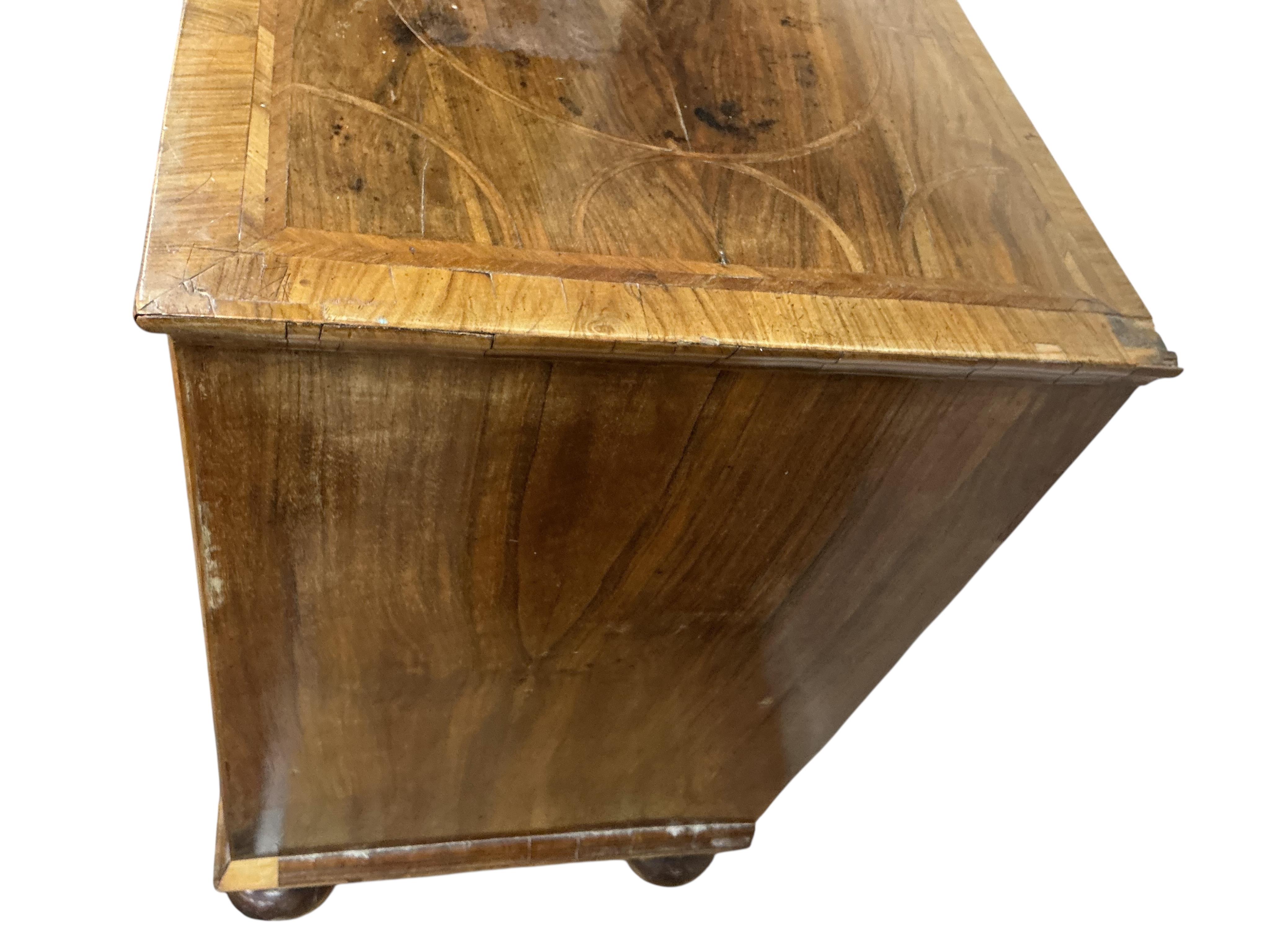 An early 18th century feather banded walnut chest, damaged, width 95cm, depth 54cm, height 91cm